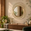 Round metal wall mirror above entryway console
